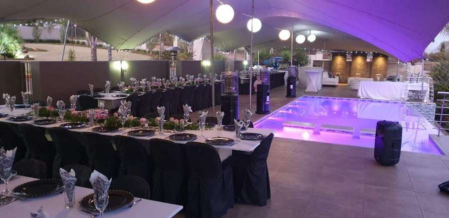 Elegant dinner tent with pool lighting